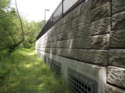 Precast concrete wall featuring flood mitigation products
